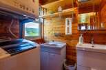 This cozy cabin boasts a convenient laundry area with a washer and dryer, perfect for longer stays.
