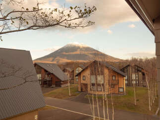 Luxury cabins nestled in a serene mountain setting, offering breathtaking views of snow-capped peaks.