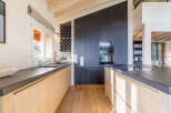 This stunning kitchen boasts a modern design with sleek countertops and light wood cabinetry.