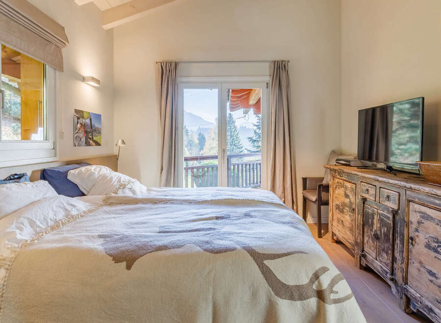 Cozy bedroom with a stunning mountain view.