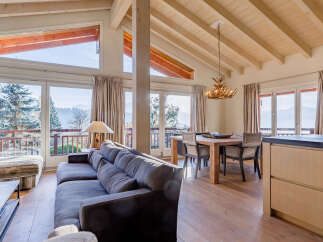 Experience luxury living in this stunning property, featuring expansive windows that frame breathtaking mountain views.