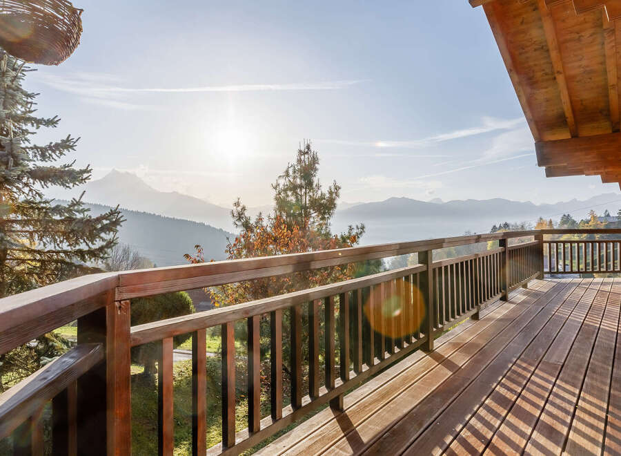Enjoy breathtaking mountain views from this stunning wooden balcony.