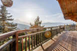 Enjoy breathtaking mountain views from this stunning wooden balcony.