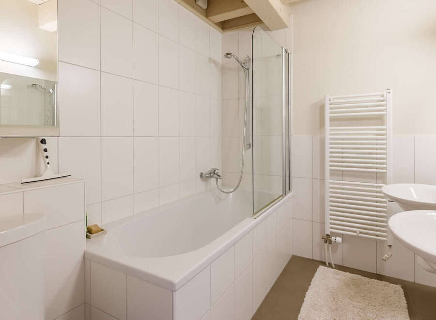 This bright and airy bathroom features a modern design with clean lines and a minimalist aesthetic.