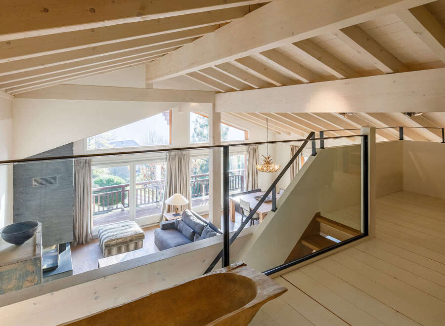 Discover the charm of this stunning loft-style home, featuring a bright and airy interior with exposed wooden beams.