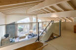 Discover the charm of this stunning loft-style home, featuring a bright and airy interior with exposed wooden beams.