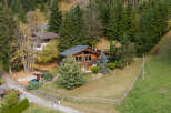 Discover a stunning chalet nestled in a picturesque mountain setting.