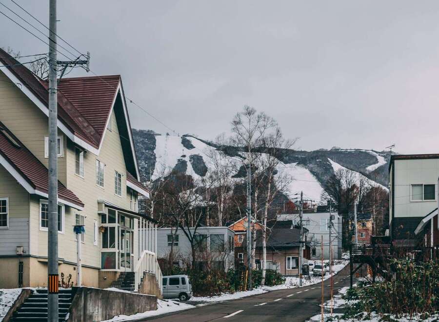 Nestled in a charming snow-dusted town, this house boasts a unique architectural design with a blend of modern and traditional elements.