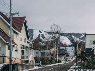 Nestled in a charming snow-dusted town, this house boasts a unique architectural design with a blend of modern and traditional elements.
