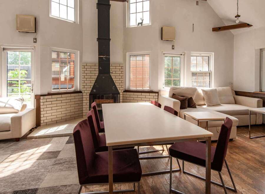 This spacious living area features a large sectional sofa, perfect for relaxing, and a dining table ideal for family meals.
