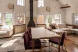 This spacious living area features a large sectional sofa, perfect for relaxing, and a dining table ideal for family meals.