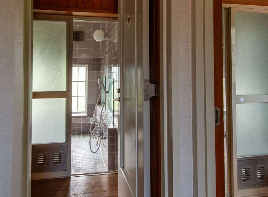 This property features a unique bathroom with frosted glass doors, offering both privacy and a touch of vintage charm.