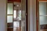 This property features a unique bathroom with frosted glass doors, offering both privacy and a touch of vintage charm.