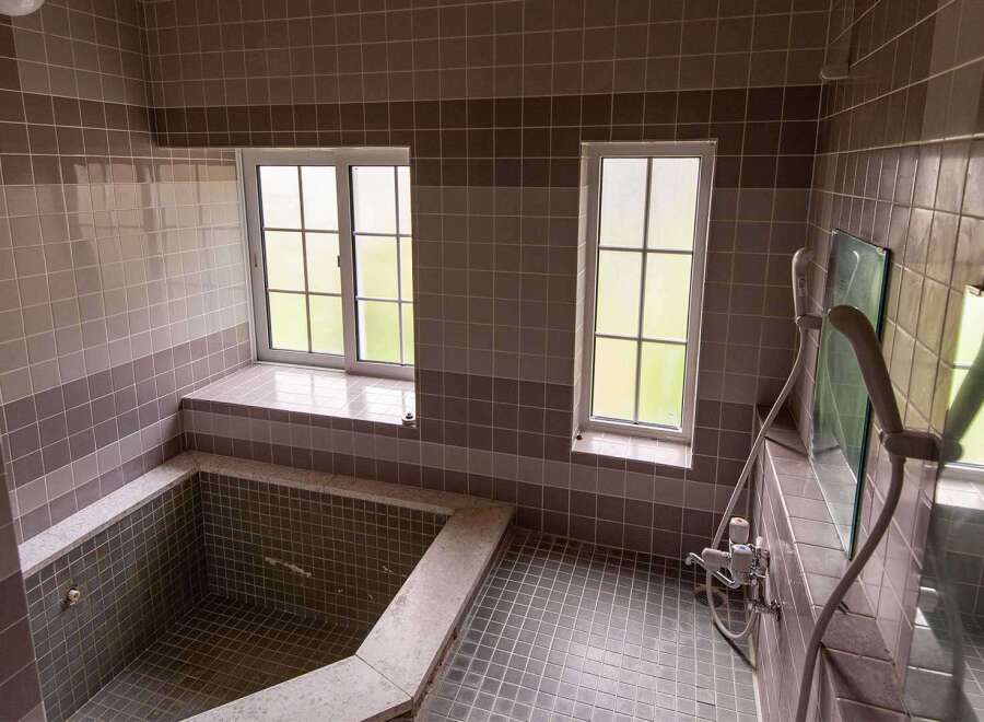 This charming bathroom boasts a unique built-in bathtub, perfect for relaxation.