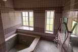 This charming bathroom boasts a unique built-in bathtub, perfect for relaxation.