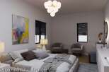 This bedroom boasts a serene atmosphere with its neutral color palette and stylish furnishings.