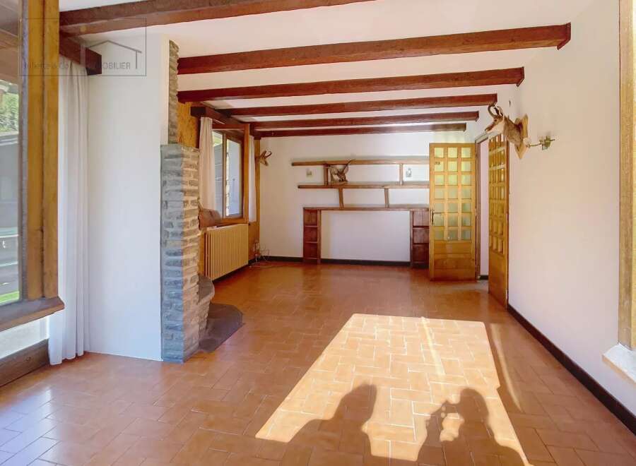 Discover the charm of this inviting living space, featuring exposed wooden beams that add warmth and character.