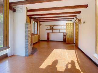Discover the charm of this inviting living space, featuring exposed wooden beams that add warmth and character.