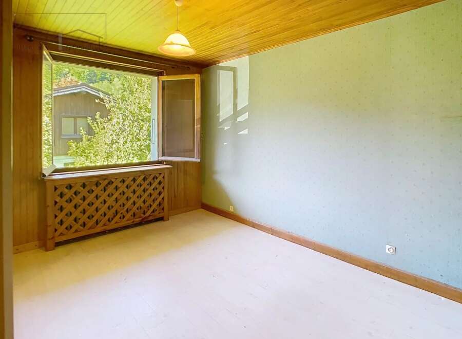 Discover the charm of this inviting room, featuring a bright, open window that frames a picturesque view.