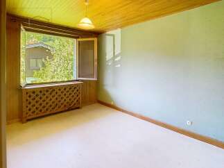 Discover the charm of this inviting room, featuring a bright, open window that frames a picturesque view.