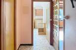 Step into this inviting hallway, showcasing a classic terrazzo floor and warm, neutral walls.