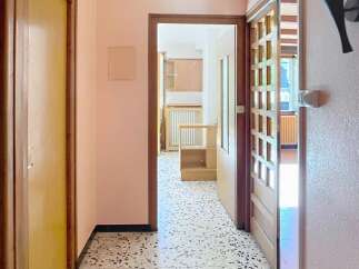 Step into this inviting hallway, showcasing a classic terrazzo floor and warm, neutral walls.