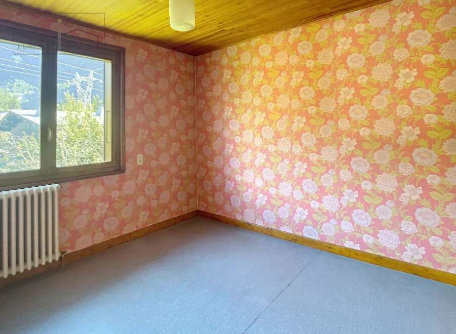 This charming room features a unique floral wallpaper that adds a touch of vintage elegance.