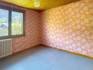 This charming room features a unique floral wallpaper that adds a touch of vintage elegance.