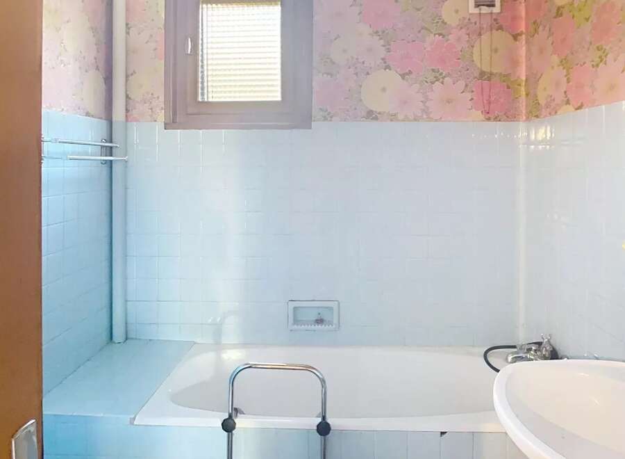 Step into this charming bathroom, featuring a classic design with a touch of vintage flair.