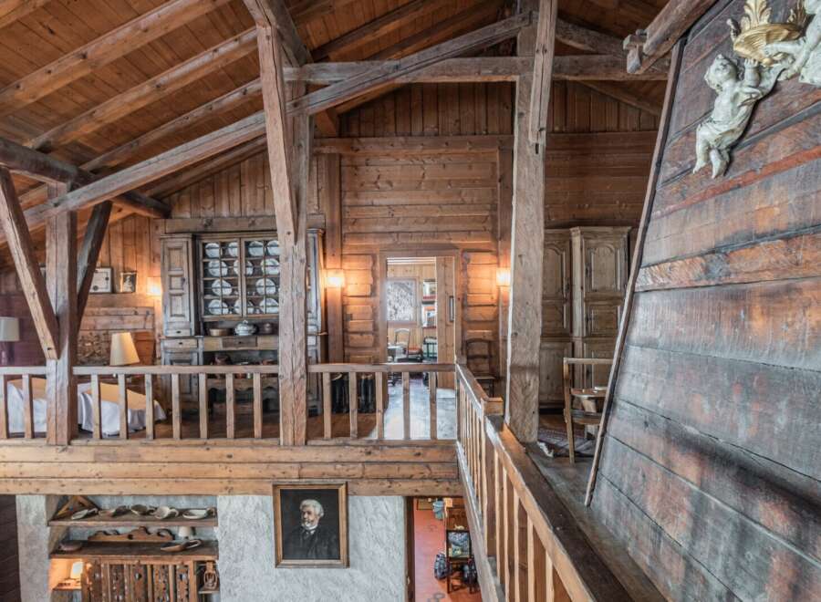 This stunning chalet boasts a unique wooden interior with exposed beams and antique furnishings.