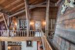 This stunning chalet boasts a unique wooden interior with exposed beams and antique furnishings.