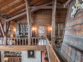 This stunning chalet boasts a unique wooden interior with exposed beams and antique furnishings.