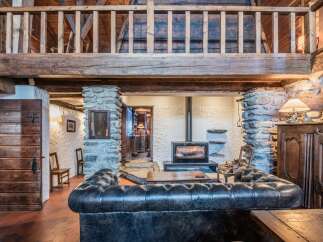 This stunning chalet boasts a beautiful stone fireplace, perfect for cozy nights in.
