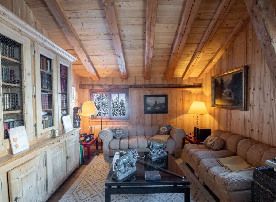Cozy mountain chalet with wood-paneled walls and beamed ceilings.