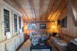 Cozy mountain chalet with wood-paneled walls and beamed ceilings.