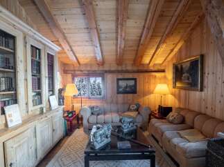 Cozy mountain chalet with wood-paneled walls and beamed ceilings.