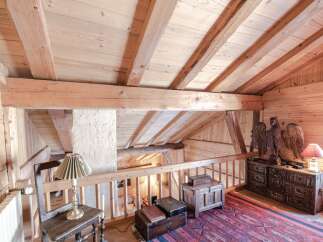 This stunning chalet boasts a magnificent wooden interior with exposed beams and a charming mezzanine level.