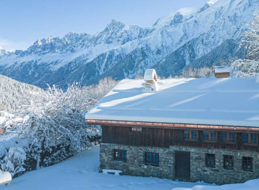 This stunning chalet boasts a picturesque snow-covered roof and breathtaking mountain views.