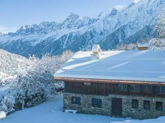 This stunning chalet boasts a picturesque snow-covered roof and breathtaking mountain views.