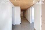 Discover this inviting property featuring a bright and airy hallway with a warm wooden ceiling.