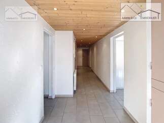 Discover this inviting property featuring a bright and airy hallway with a warm wooden ceiling.