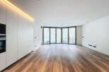 Stunning modern apartment boasting expansive windows offering abundant natural light and views.