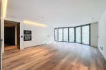 Stunning open-plan living space with expansive curved windows offering abundant natural light and views.