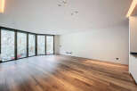 Spacious living area with stunning views and hardwood floors.
