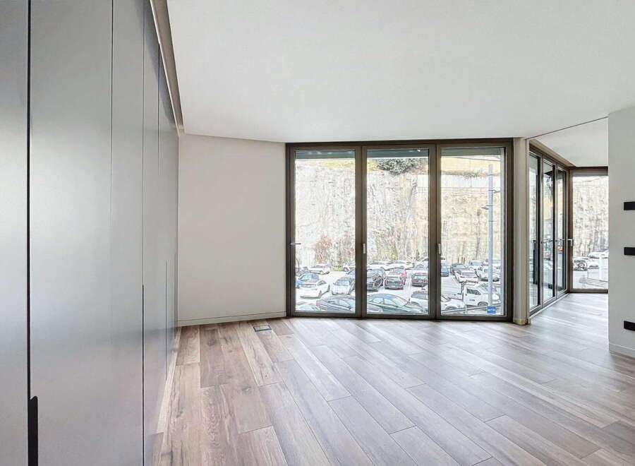Modern apartment boasting expansive windows offering stunning views.