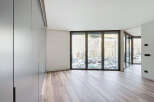 Modern apartment boasting expansive windows offering stunning views.