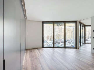 Modern apartment boasting expansive windows offering stunning views.