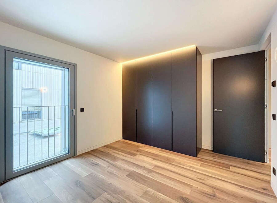 Modern apartment boasting sleek built-in wardrobes and stylish flooring.