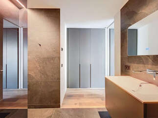 Luxury bathroom with modern design features, including a sleek countertop sink and built-in storage.