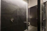 Modern bathroom with dark slate tiles and sleek fixtures.